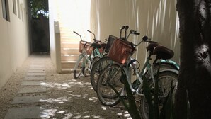 Un'area di parcheggio con biciclette appoggiate a un muro.