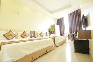A hotel room with two beds, a desk, a television, and a window with curtains. - Anova 2 Hotel (Hanoi)