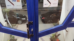 A blue-framed window with two Visa MasterCard signs advertising QNB Al-Ahli.
