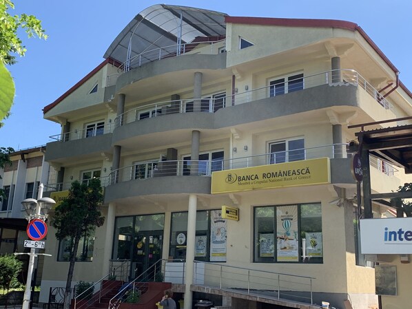 Un edificio de varios pisos con un cartel de Banca Românească, un banco.