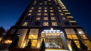 A modern hotel with a prominent entrance, large windows, and a well-lit facade. - Stellar Hotel (Incheon)