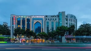 A modern building with a prominent archway and signage indicating it is a business center. - Zhuhai Asian Star Hotel (Zhuhai)