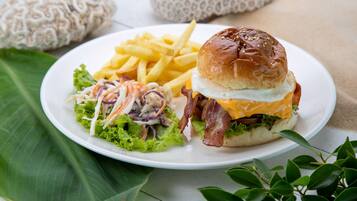 A plate with a burger, fries, and coleslaw.