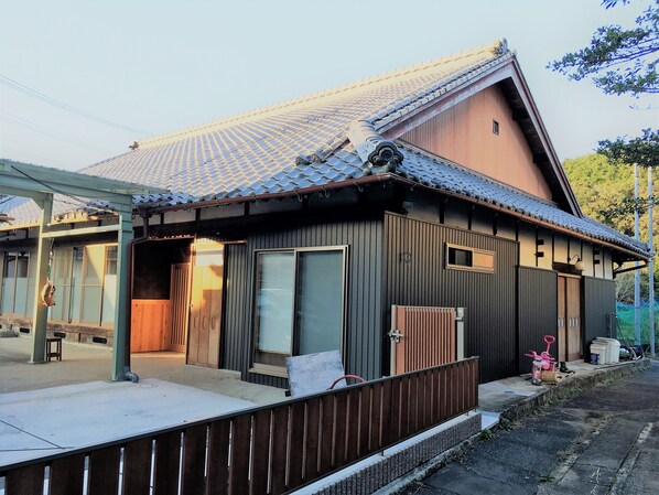A traditional Japanese house with a tiled roof, wooden exterior, and a small porch area. - Guest House Ilonggo (Tsu)