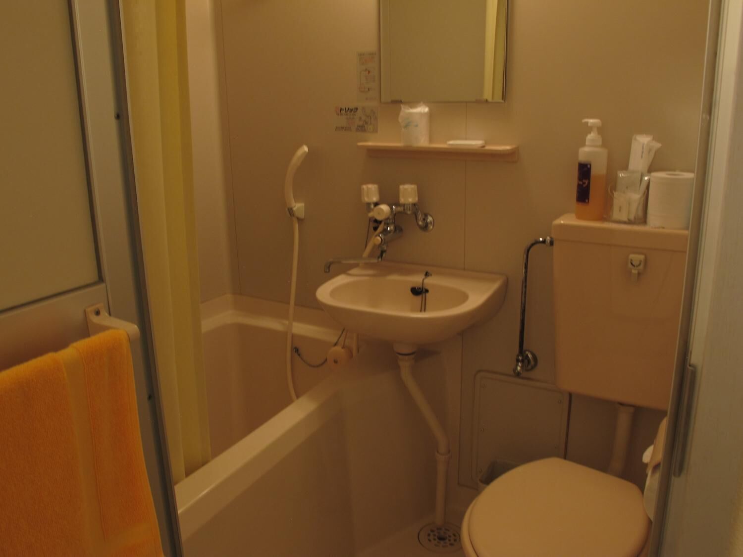 A small bathroom with a bathtub, sink, and toilet.