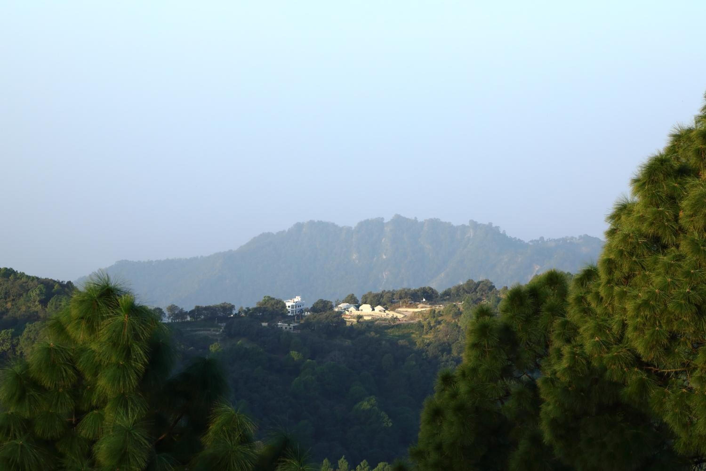 A mountainous landscape with scattered buildings.