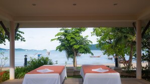 A room with two beds, a view of the sea, and a palm tree. - Blue Beach Grand Resort and Spa (Rawai)