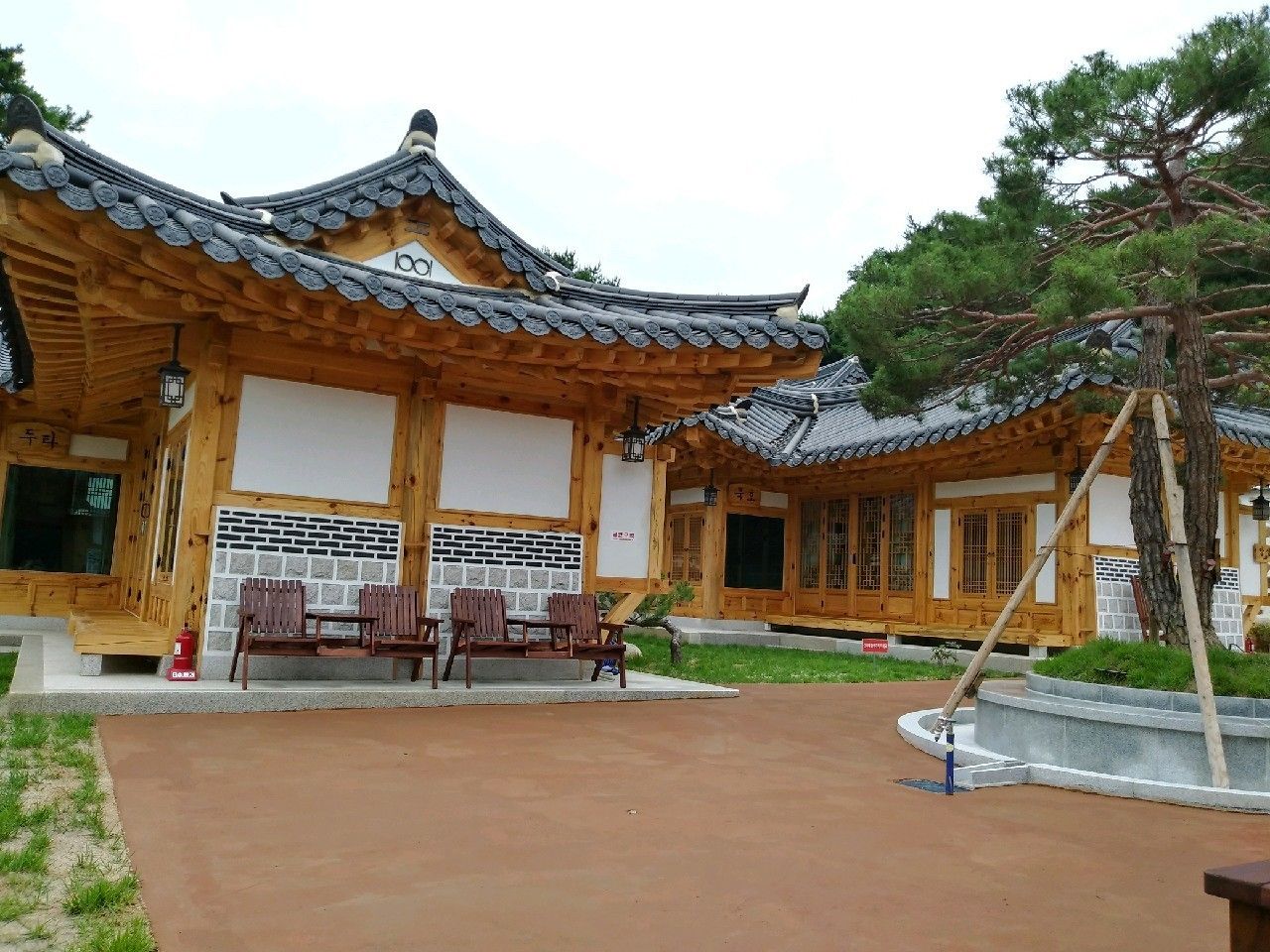 A traditional Korean-style building with wooden architecture and tiled roofs.