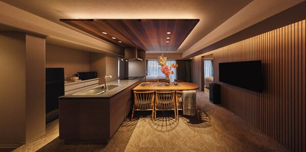 A modern kitchen with a central island, built-in appliances, and a flat-screen TV mounted on the wall. - Residence Hotel Hakata 19 (Fukuoka)