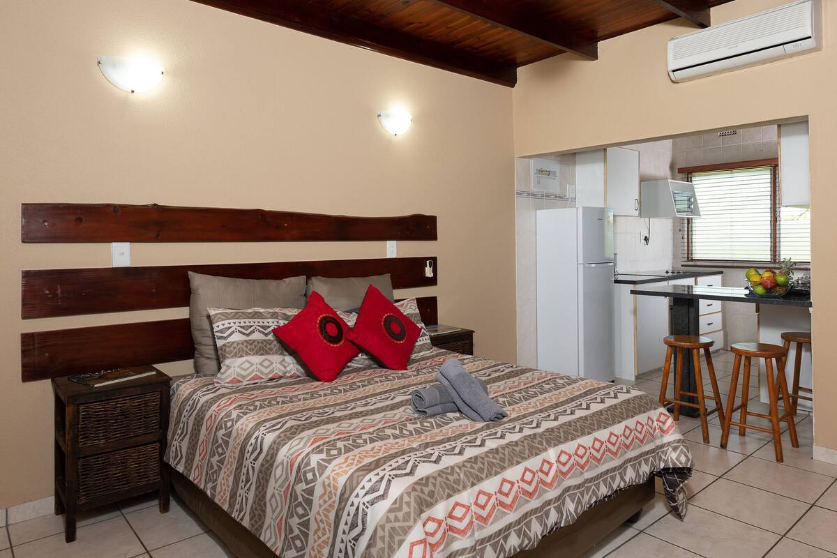 Desk, iron/ironing board, bed sheets