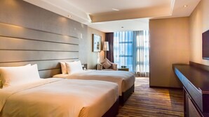 A hotel room with two beds, a desk, a chair, and a large window with curtains. - Chongqing YiMei Hotel (Chongqing)