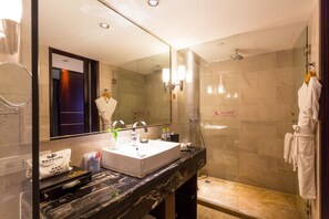 A modern bathroom with a large mirror, a white sink, and a glass-enclosed shower area. - Chongqing YiMei Hotel (Chongqing)