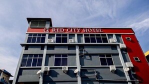 A multi-story building with a red and grey facade, featuring the signage "RED CITY HOTEL" at the top. - Red City Hotel (Lawas)