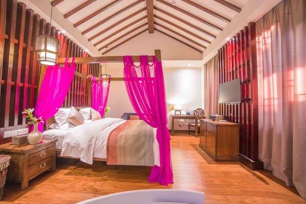 A well-lit bedroom with a wooden ceiling, a bed with white bedding, a nightstand with a vase, and a wooden cabinet. - Li Jiang Tang Feng Yard No.4 (Lijiang)