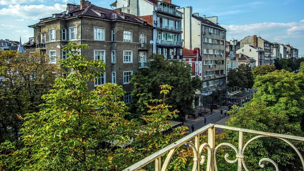 A row of multi-story buildings with balconies, surrounded by trees. - Vitosha Flat (Sofia)