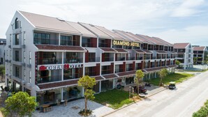 A multi-story hotel with a modern design, featuring balconies and large windows. - Sofia Hotel (Phu Quoc)