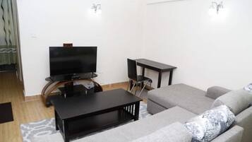 Apartment, 1 Bedroom | Living room | Flat-screen TV