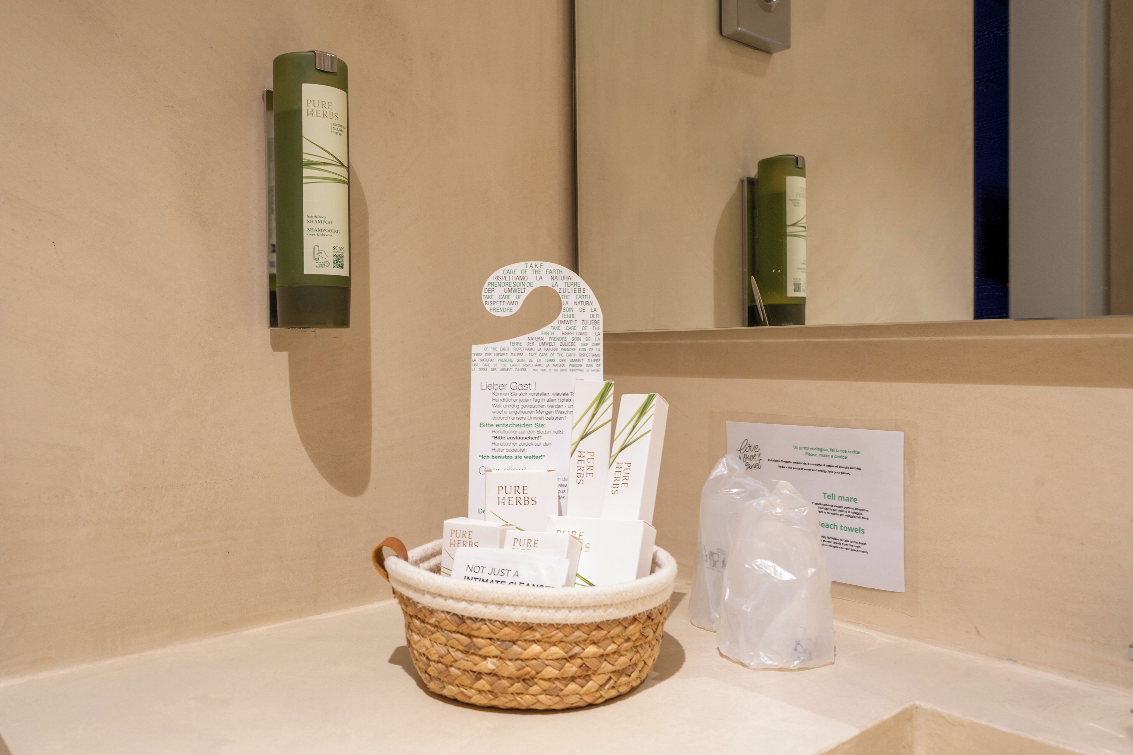 A bathroom with a woven basket containing toiletries, a mirror, and informational signs.