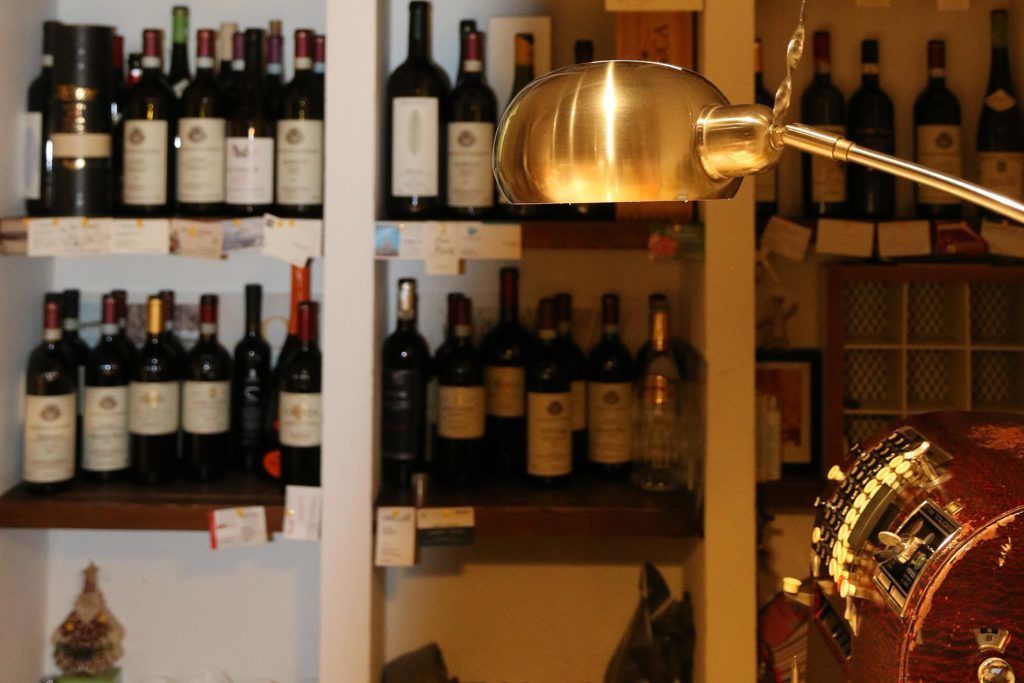 A wine rack with various bottles and a decorative item.