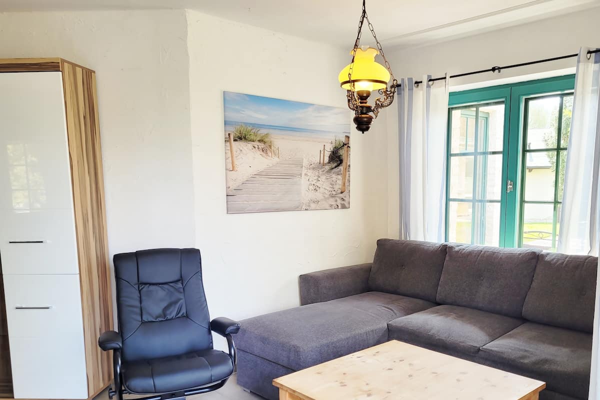 Departamento, 2 habitaciones | Área de sala de estar | Televisión de pantalla plana de 90 cm con canales por cable