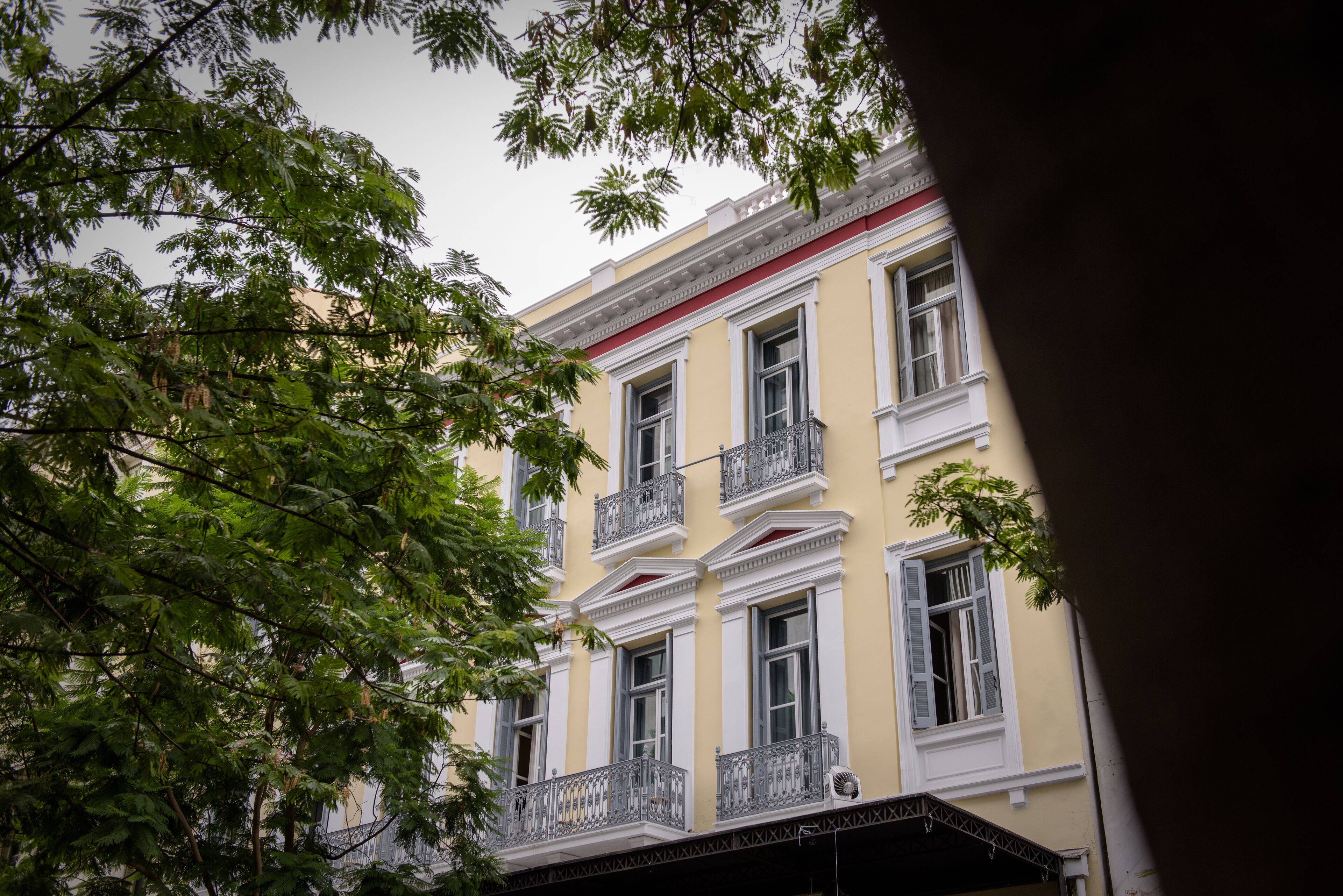 A multi-story building with balconies and a balcony with a metal railing.