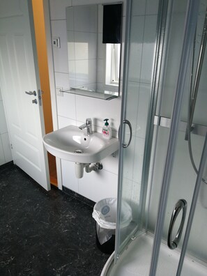 Shower, hair dryer, slippers, towels