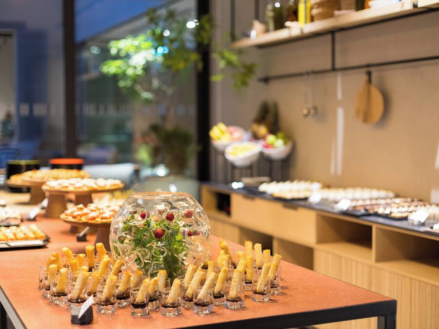 A buffet with various food items and a decorative centerpiece.