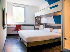 A bunk bed room with a desk and chair, a window with a view, and a ladder. - ibis budget Archamps Porte de Genève (Archamps)