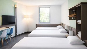 A hotel room with two beds, a desk with a chair, a TV, and a window. - ibis budget Archamps Porte de Genève (Archamps)