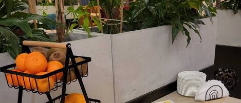 A buffet table with fruits and a fruit basket.