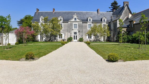 A large, historic building with a symmetrical facade, a central entrance, and a gravel driveway leading to the main entrance. - Château de la Grand'Cour (Grandchamp-des-Fontaines)