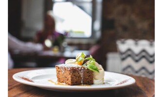 A slice of cake on a plate with a blurred background.