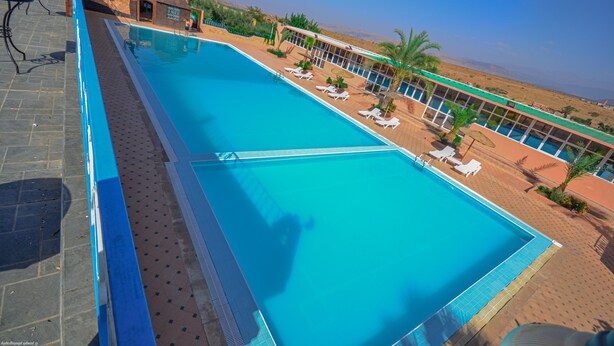 Seasonal outdoor pool, an infinity pool, pool umbrellas, pool loungers