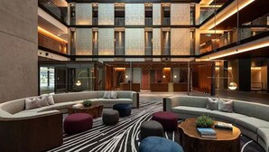 A spacious atrium with a central seating area, multiple floors, and a modern design. - Park Hyatt Auckland (Auckland)