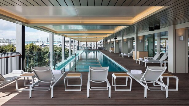 A poolside area with lounge chairs and a swimming pool. - Park Hyatt Auckland (Auckland)