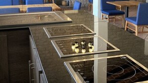 A restaurant with stone walls, blue chairs, and a central black stove. - Hotel Sand's San Luis Potosí (San Luis Potosi)