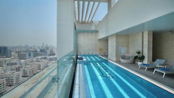 Een buitenzwembad en ligstoelen