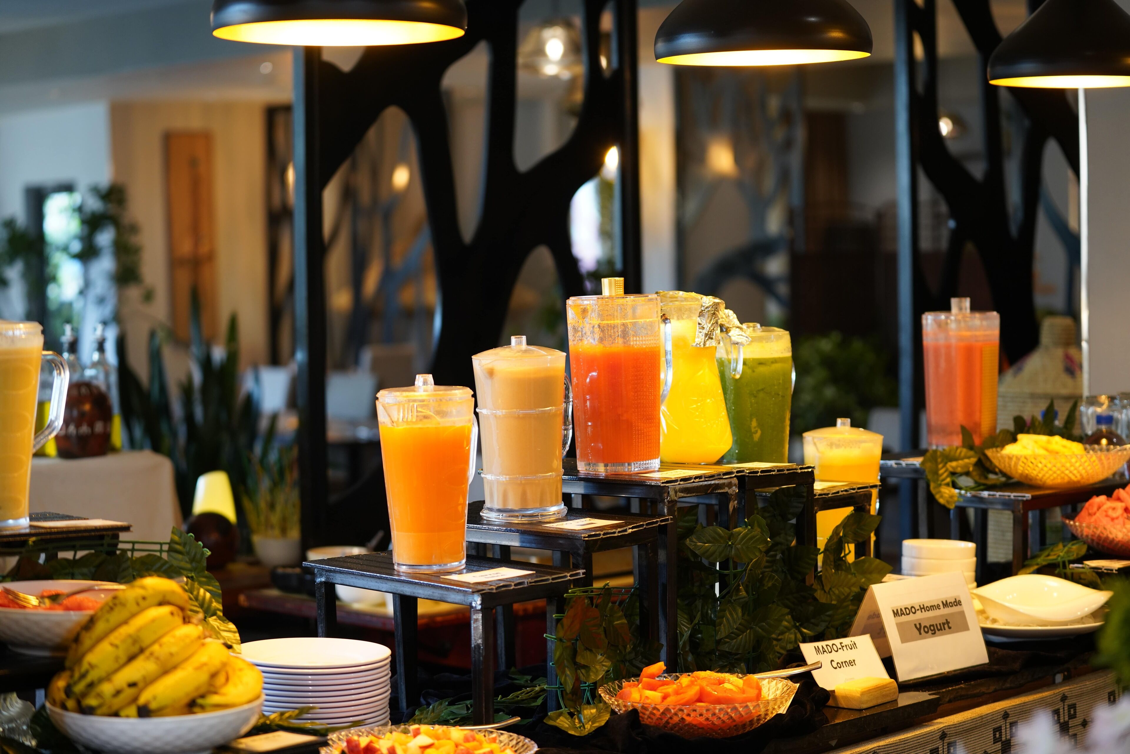 A buffet with various fruit options and beverages.