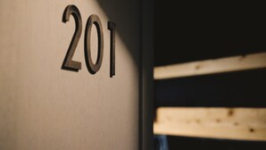A wall with the number '201' in a modern font. - PITO BEPPU hostel & cafe (Beppu)