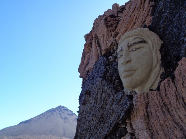 A rock formation with a carved face. - Pensao Casa José Doce (Santa Catarina do Fogo)