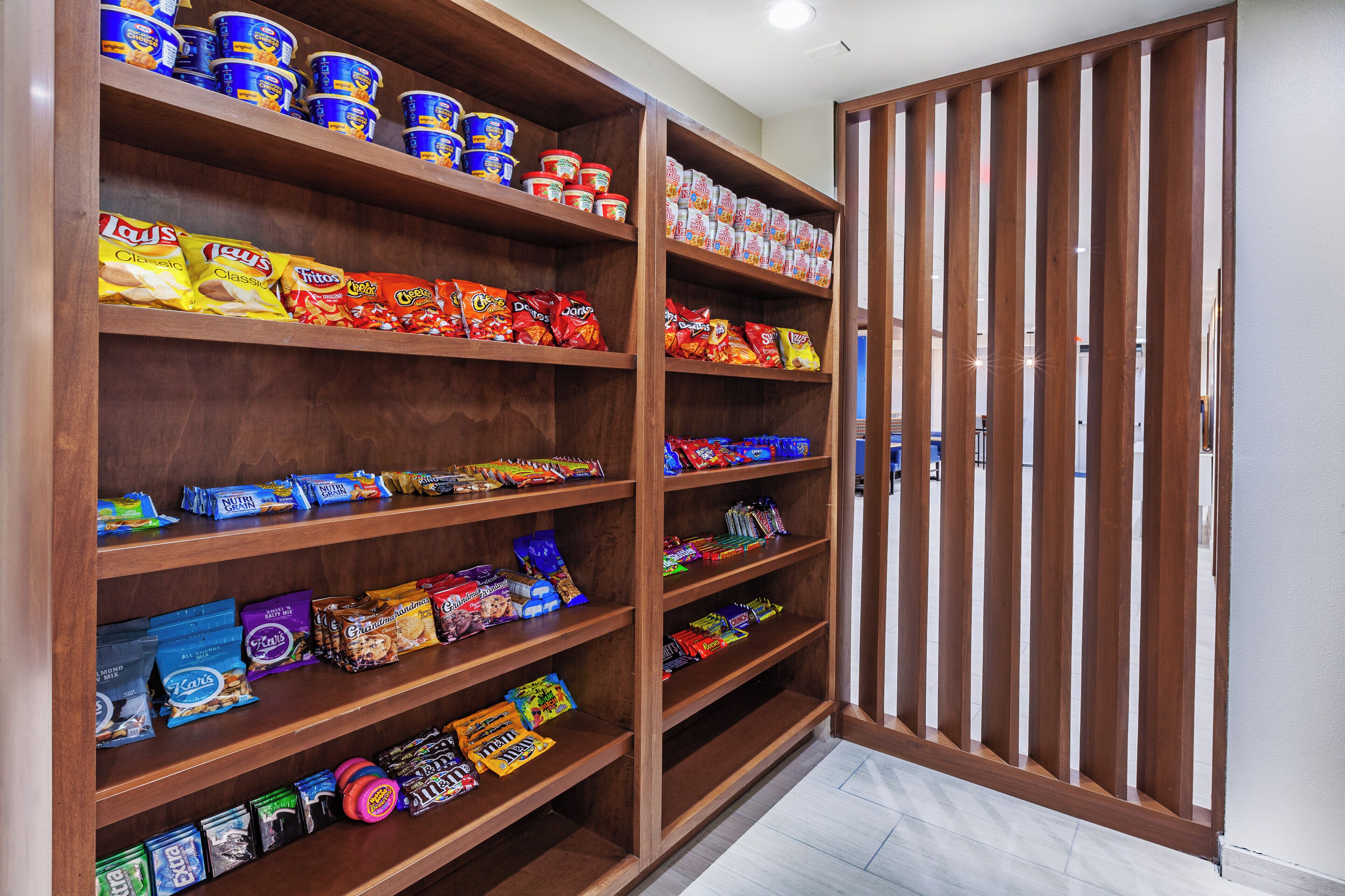 A pantry stocked with various food items including canned goods, chips, and snacks.