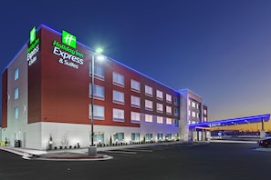 A Holiday Inn Express building with a modern design, featuring a prominent sign and a parking lot. - Holiday Inn Express & Suites Tulsa Northeast - Owasso by IHG (Owasso)