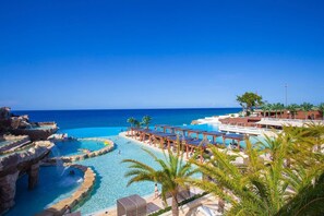 A resort with a large pool area, a separate pool with a waterfall, and a view of the ocean. - Sosua Ocean Village Properties by Calisto Stays (Sosúa)