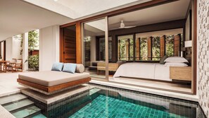 A modern bedroom with a large bed, a seating area, and a view of the outdoors. - Mandarin Oriental, Desaru Coast (Bandar Penawar)