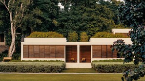 A modern house with a flat roof, large windows, and a well-maintained garden. - Mandarin Oriental, Desaru Coast (Bandar Penawar)