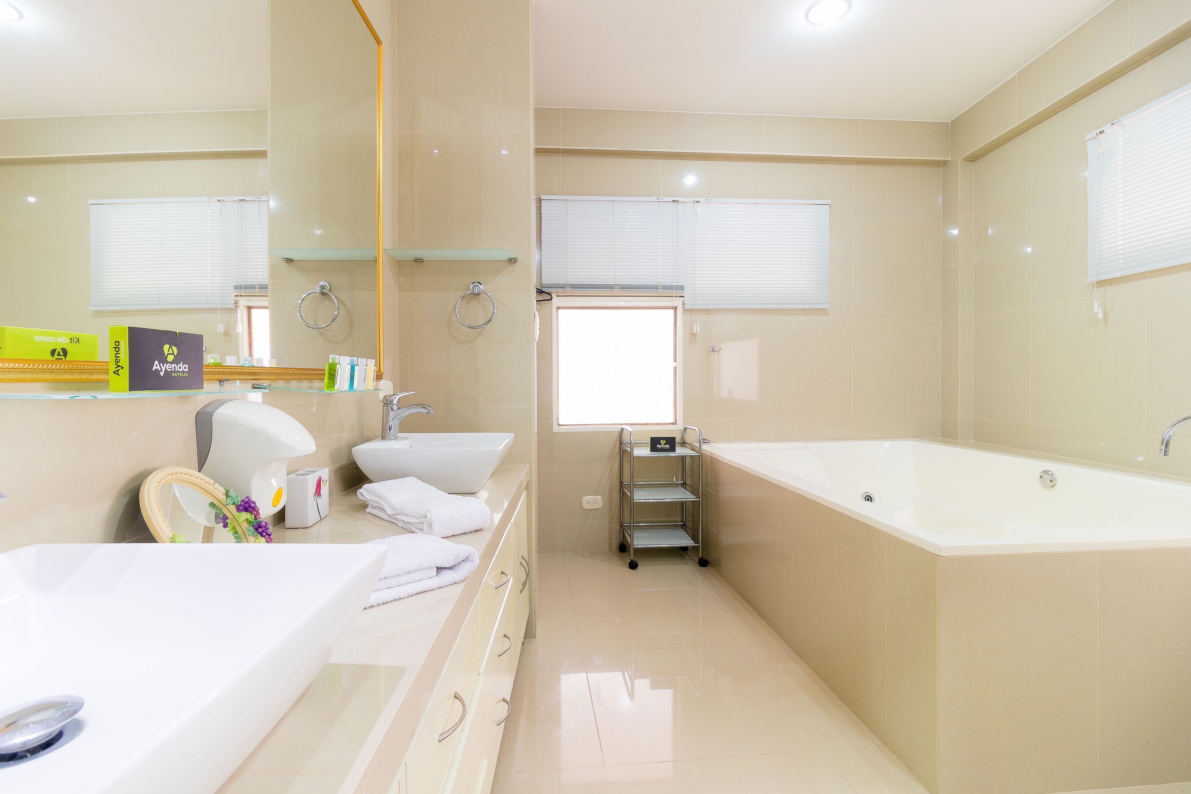 A modern bathroom with a large bathtub, a sink, and a vanity.