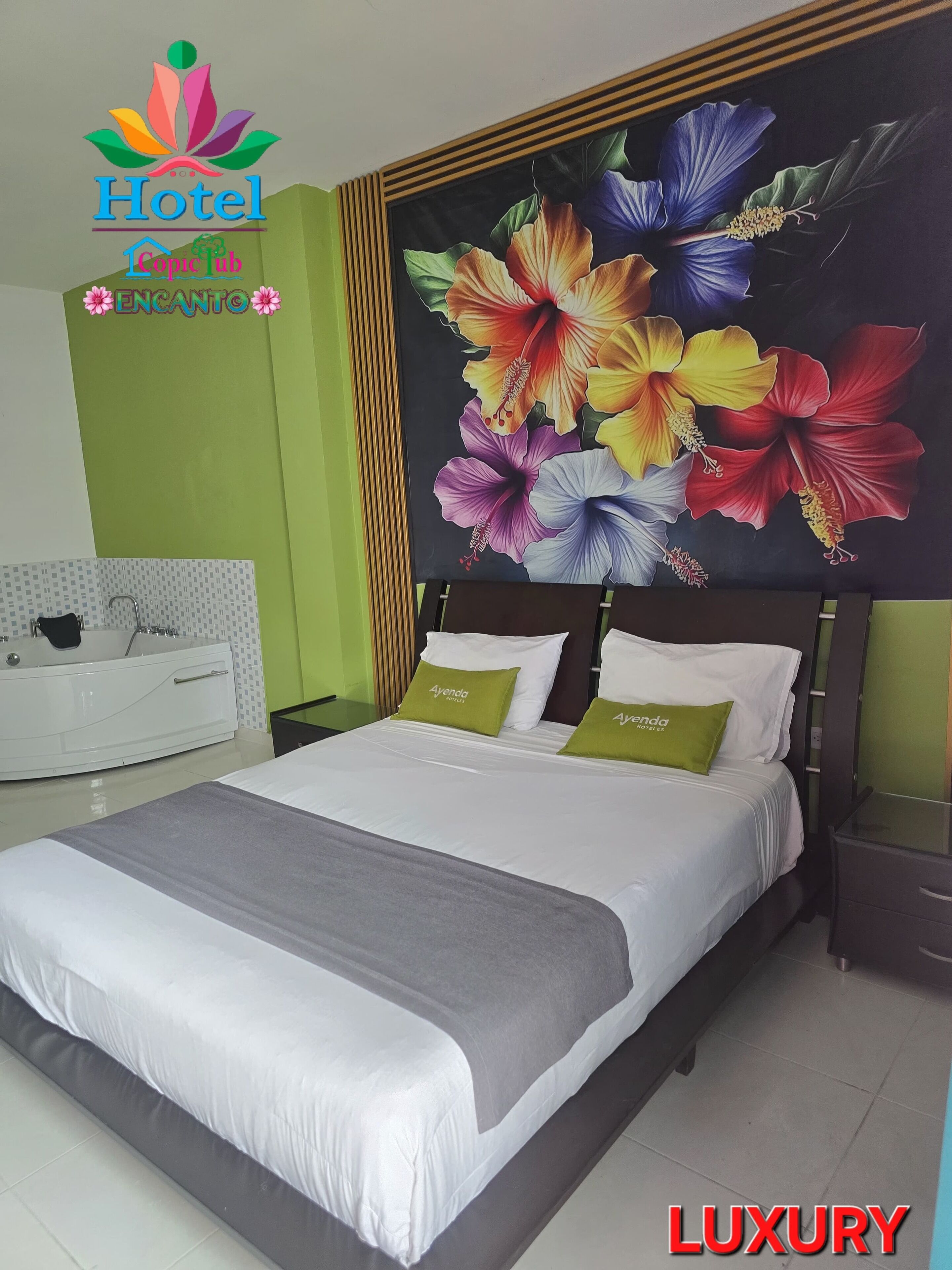 A hotel room with a large bed, green walls, a floral mural, and a bathtub.