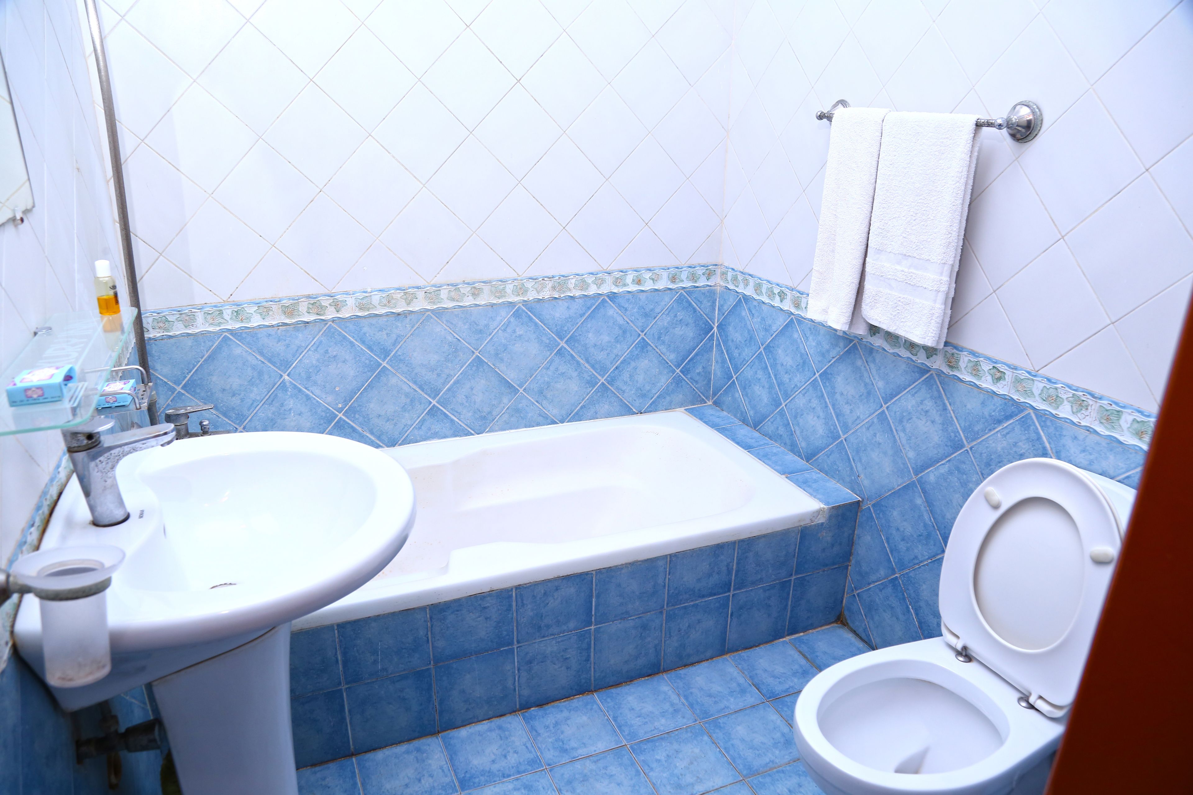 A bathroom with a bathtub, toilet, and sink.
