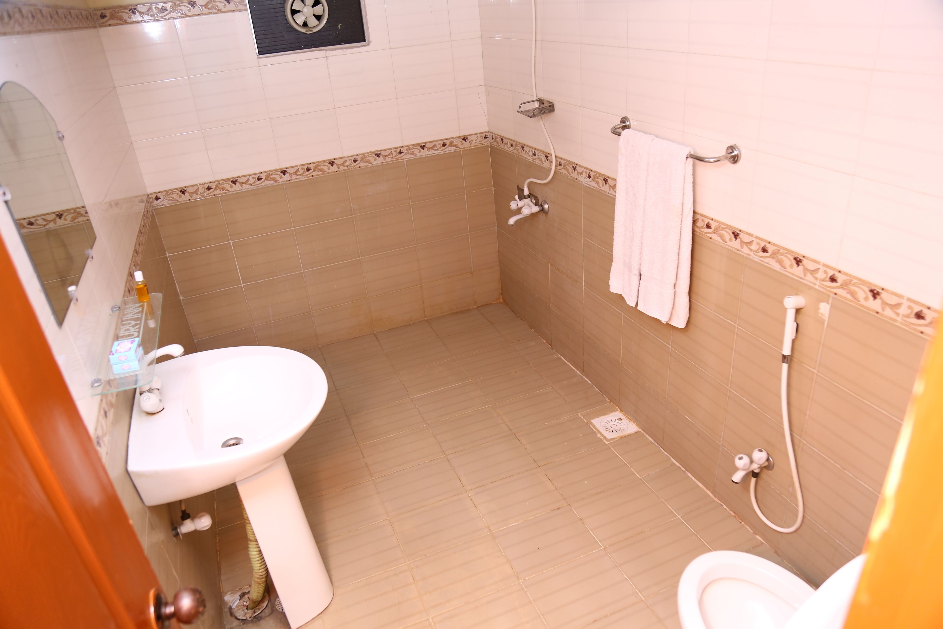 A bathroom with a sink, toilet, and shower.