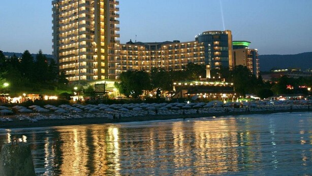 A multi-story hotel with balconies, a pool area, and a waterfront view. - Bonita Beach Hotel (Golden Sands)